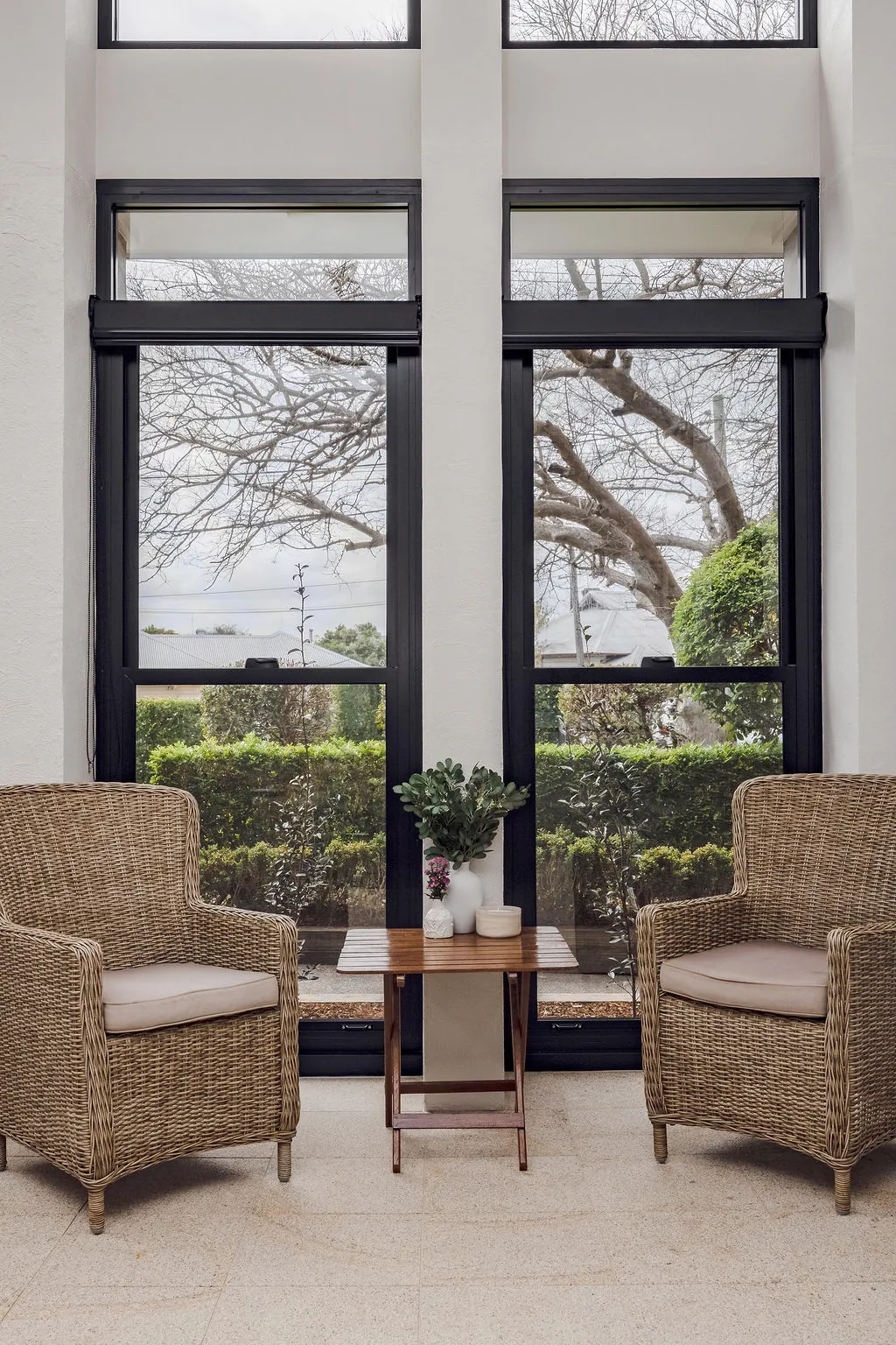 Sitting nook in front of floor-to-ceiling black framed windows