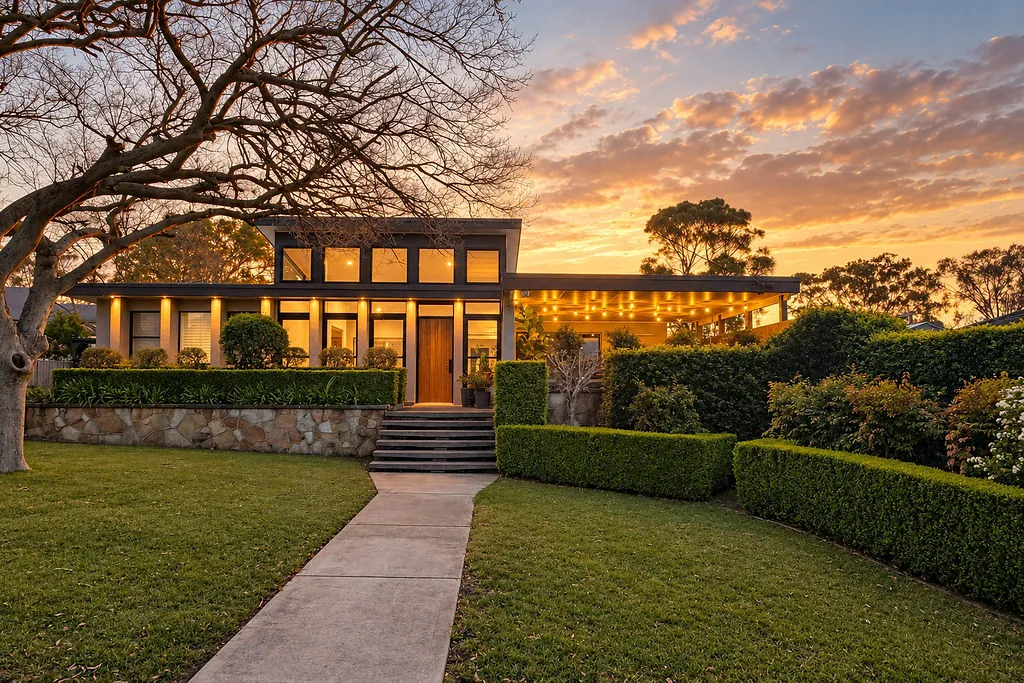 Front of the renovated Taree home lit up at dusk