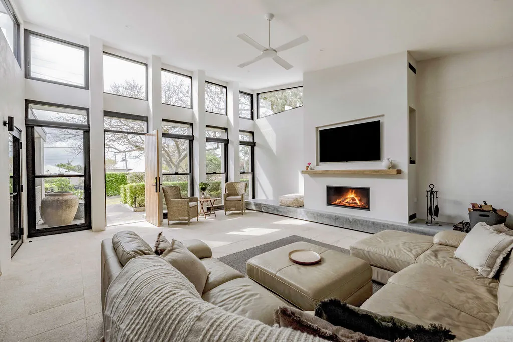 Lounge room built in the former open courtyard, with the new fireplace lit