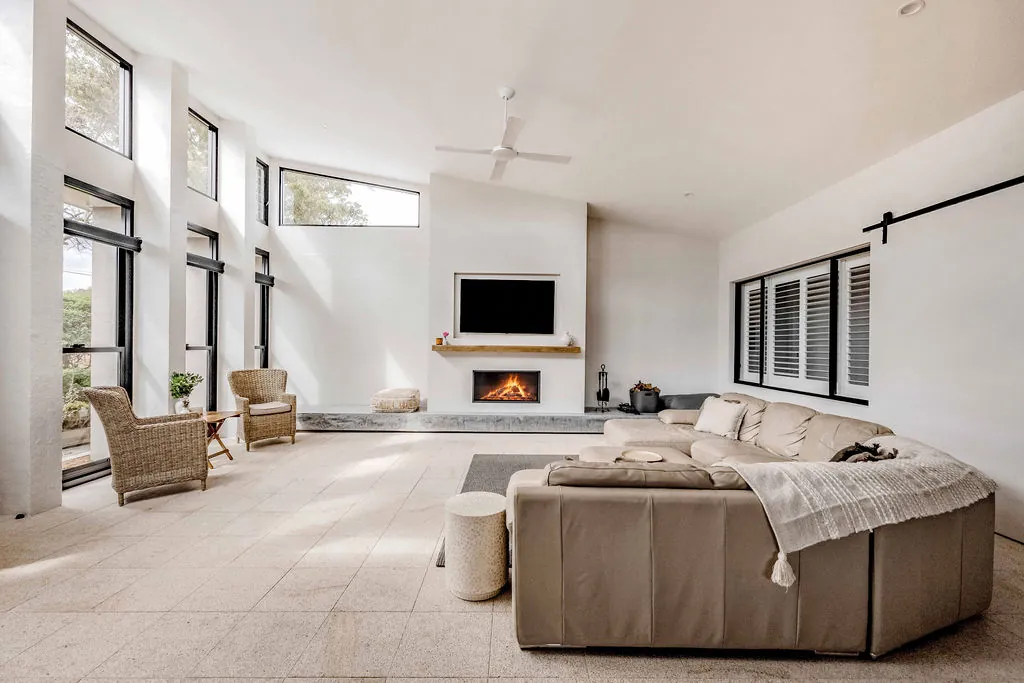 New lounge room looking towards the fireplace and plantation shutters